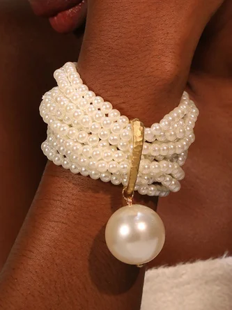 Multi-layered beaded artificial crystal bracelet with large pearl pendant.